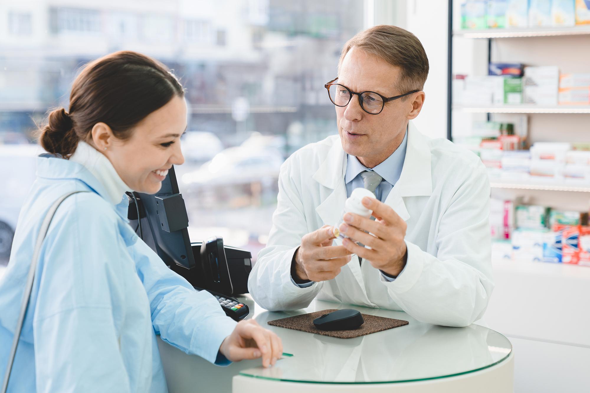 A pharmacist telling his patient about their medicine